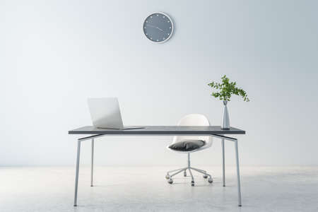 Cold shadows interior design of home office waork place with modern laptop on dark marble table, gray wall clock on light background and concrete floor, 3D renderingの写真素材