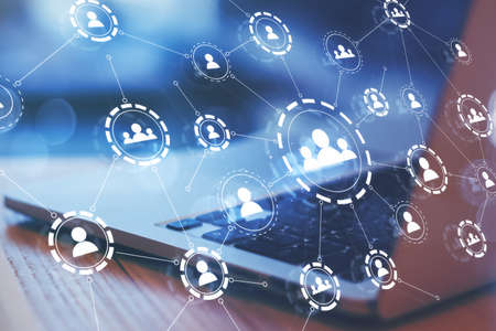Social network concept with digital application media icons connected by lines on opened laptop...