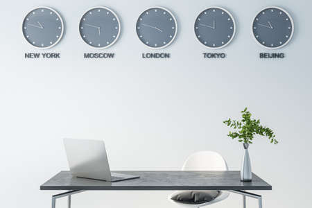 Time of world cities on wall clock in modern office space with dark marble table surface, laptop and green plane in glass vase, 3D renderingの写真素材