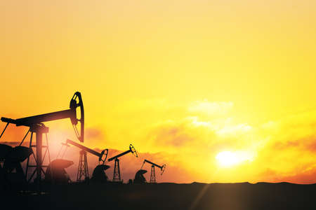 Oil field pumpjack silhouttes with amazing nature view at sunrise. 3D renderingの写真素材