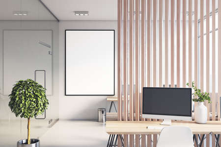 White poster in black frame with copyspace in sunny coworking office with stylish workspaces, green...