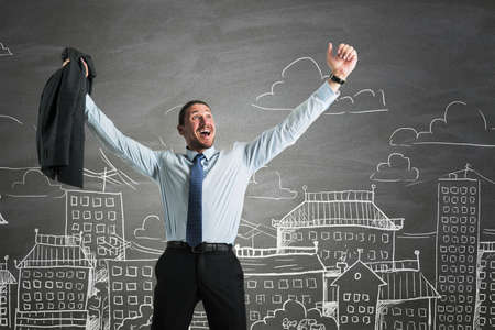 Businessman standing and having his hands raised in joy with the city street hand-drawn sketch with multiple buildings and flats in the background, future success and confidence conceptの写真素材