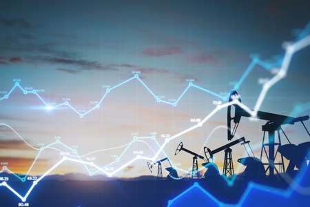 Fuel and oil industry quotes concept with digital financial chart diagram and oil pump jacks on a field at sunset. Double exposureの写真素材