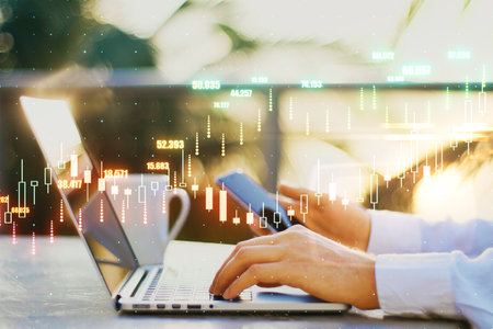Forex exchange concept with glowing digital financial chart candlestick on businessman hands on...