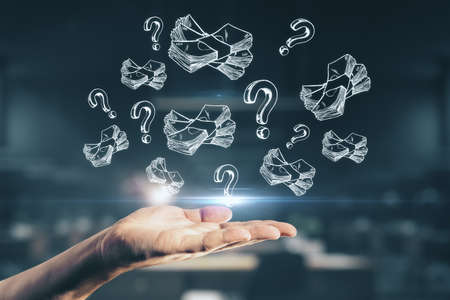 Hand holding dollar and question marks sketches on a dark background, startup and business education conceptの写真素材