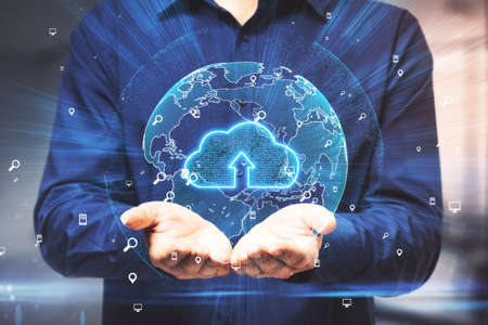 Business cloud computing concept with man carries digital model of the Earth and cloud symbol...