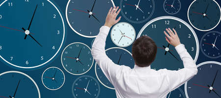 Businessman with abstract glowing blue clock background. Time management and deadline concept