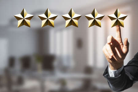 Customer experience and service rating concept with businessman touching digital five golden star...