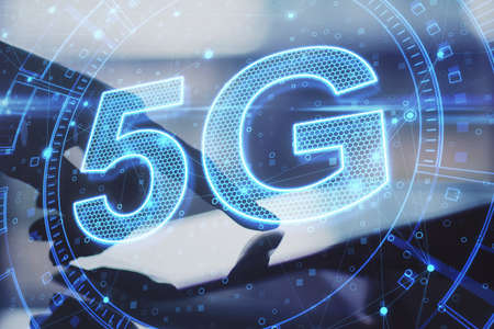 Hand using tablet with 5G network digital hologram and internet of things background. High speed internet concept. Double exposureの写真素材
