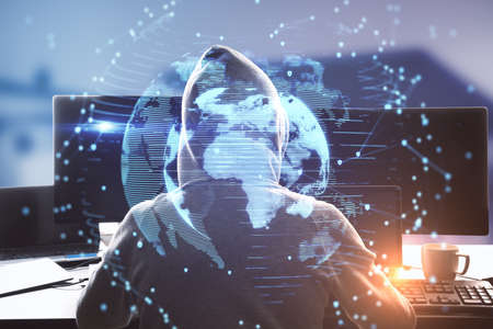 Back view of hacker using computer with glowing blue globe on blurry background, Global...