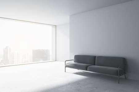 Contemporary concrete office waiting area with window and city view, comfortable couch and blank mockup place on wall. Mock up, 3D Renderingの写真素材