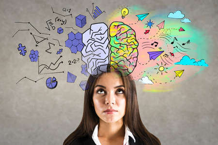 Portrait of attractive young european businesswoman with creative colorful brain sketch on wall background. Brainstorm and hemispheres conceptの写真素材