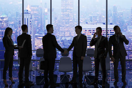 Backlit businesspeople standing in panoramic office interior with city view. Teamwork and coworking...