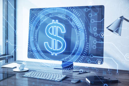 Close up of creative glowing dollar sign and computer monitor on office desktop background with hologram. Currency and online banking concept. Double exposureの写真素材