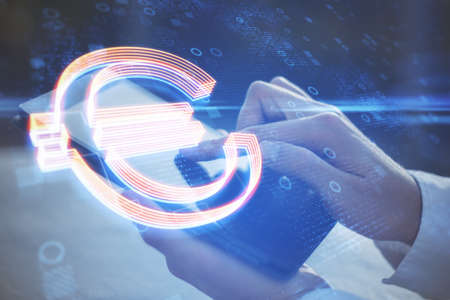 Close up of hands using pad with glowing euro sign on blurry background with circles. Futuristic...