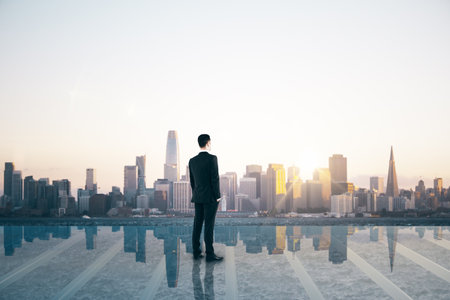 Success and satisfaction concept with businessman back view on rooftop with transparent floor looking on megapolis city skylineの写真素材