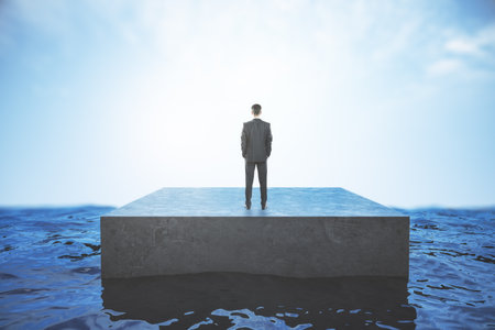 Back view of young businessman standing on pathway in bright sky. Success, tomorrow and future conceptの写真素材