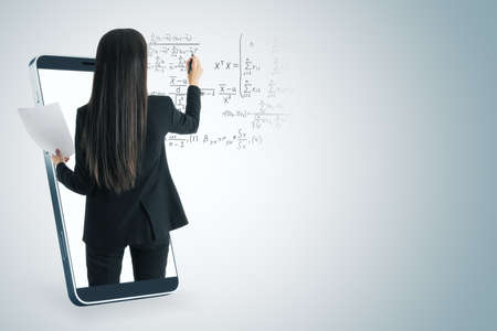 Attractive young european businesswoman inside abstract smartphone writing mathematical formulas on...