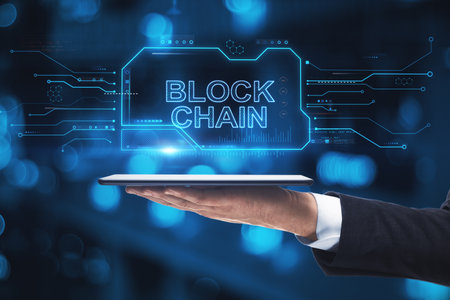 Close up of hand holding tablet with creative blockchain hologram on blurry bokeh background....