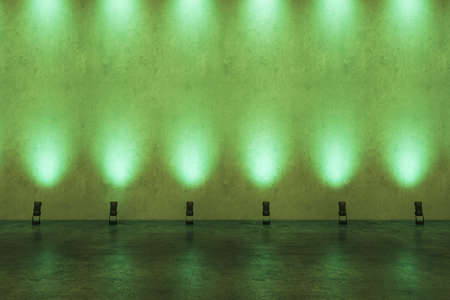 Front view on blank presentation wall in empty loft style hall illuminated by green lights. 3D rendering, mockupの写真素材