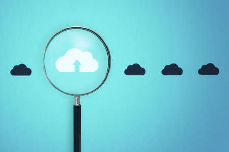 Magnifier zooming in on cloud icon on blue background. Cloud computing concept. 3D Renderingの写真素材