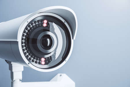 Close up of cctv camera on light blue background with mock up place for your text and advertisement....