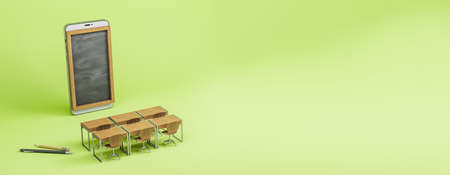 Abstract wide chalkboard screen smartphone, wooden desk and chairs on green background. Online...