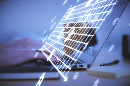 Close up of hands at desk using laptop computer with abstract glowing money mesh on blurry background. Cryptocurrency and online banking conceptの写真素材