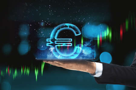 Close up of hand holding tablet computer with creative glowing polygonal euro city hologram on...