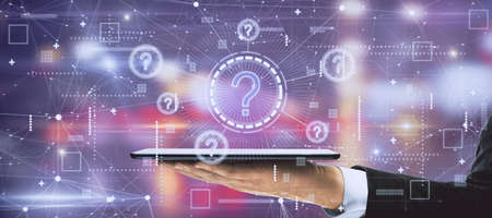 Businessman hands holding tablet with creative glowing question marks interface on blurry background. Technology, business help and faq conceptの写真素材
