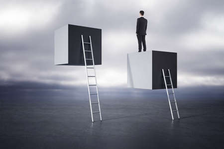 Businessman standing on abstact ladder with box on dull sky background. Career growth and success...