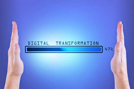 Man hands holding abstract glowing loading bar on blue wall background. Digital transformation, internet, progress and technology conceptの写真素材