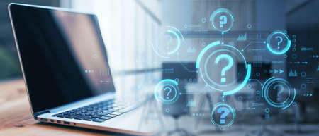 Close up of laptop on desktop with blurry abstract question mark interface. Problem solving and faq...