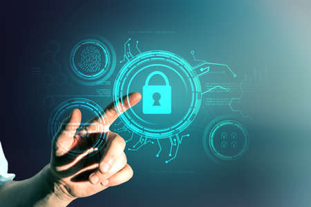 Male hand pointing at creative glowing blue digital padlock interface on dark background. Online...