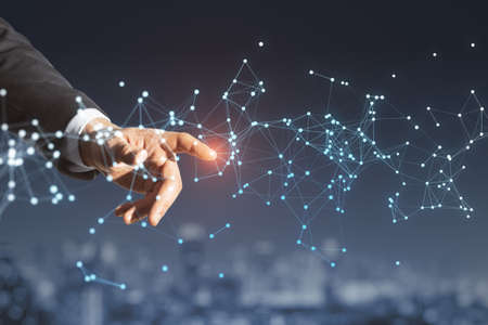 Close up of man hand pointing at glowing polygonal mesh on blurry night city background. Technology,...