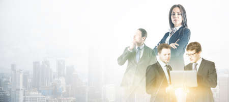 Businesspeople working together on bright white city background with mock up place. Teamwork and success concept. Double exposureの写真素材