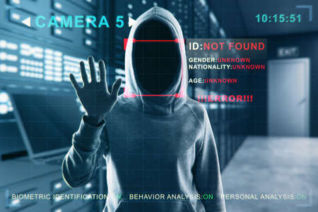 Security camera not recognizing hacker in hoodie standing in blurry server room interior. ID, scanning, data theft and cctv concept. Double exposureの写真素材