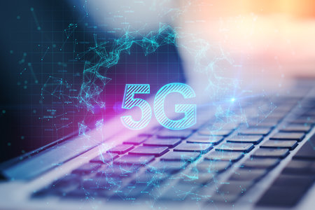 Close up of laptop with abstract glowing 5G hologram on dark background. Internet speed, wireless...