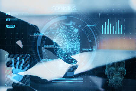 Close up of backlit female hand pointing at tablet with abstract glowing finger scanning hologram on dark background. Fingerprint and identity concept. Double exposureの写真素材