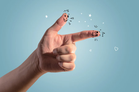 Close up of businessman hand with drawn smileys on blue background. Creativity and emoticon concept