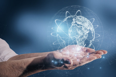 Close up of male hand holding abstract glowing globe hologram on blurry blue background. Digital network, data and science conceptの写真素材