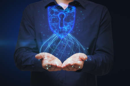 Close up of male hands holding glowing blue padlock hud on dark background. Safety, web security and...