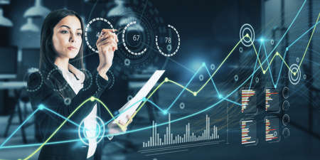 Attractive young european businesswoman using creative glowing business graph on blurry office...