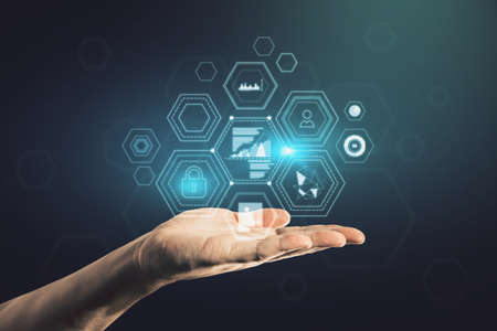 Close up of businessman hand holding creative business chart hologram on blurry background....