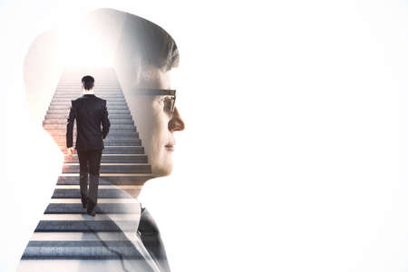 Creative image of attractive european male walking on abstract stairs on white background with mock up place. Success and career growth concept. Double exposureの写真素材