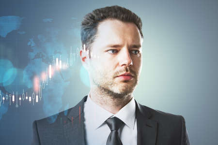 Portrait of attractive young european businessperson thinking about candlestick forex graph and map on gray background with mock up place. Trade, economy and growth concept. Double exposureの写真素材