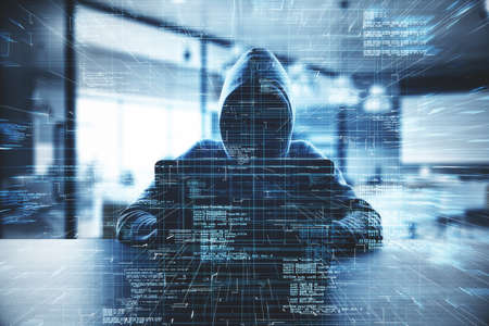 Hacker at desk using computer with creative glowing coding big data interface on dark interior...