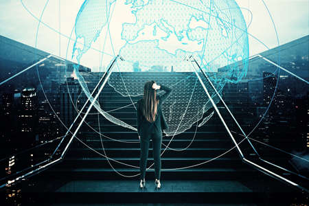 Young european businesswoman standing on stairs with abstract globe hologram. Business, growth and...