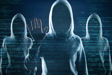 Creative image of a group of hackers in hoodies standing on abstract dark coding wallpaper. Malware,...