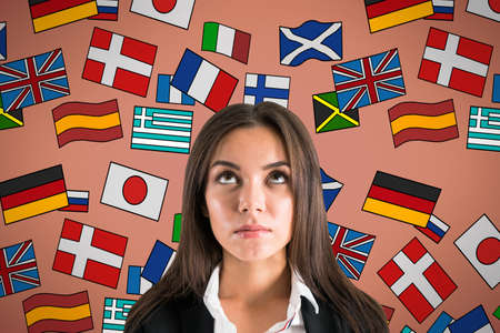 Portrait of attractive young european businesswoman with abstract colorful flag drawings. Travel,...